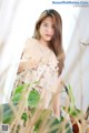 A woman in a floral dress posing for a picture.