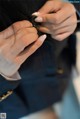 A close up of a woman's hands holding a button.