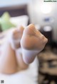 A close up of a person's feet in white stockings.