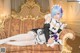 A woman in a maid outfit laying on a couch.