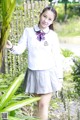 A woman in a school uniform posing for a picture.