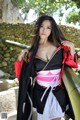 A woman in a black and red kimono posing for a picture.