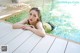 A woman laying on the edge of a swimming pool.