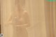 A naked woman standing in front of a shower curtain.