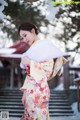 A woman in a kimono is standing in the snow.