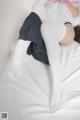 A woman laying on top of a bed wearing white stockings.