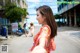 A woman taking a selfie on the street. 