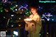 A woman in a bathrobe holding a bowl of food.