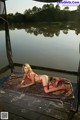 A woman in a red bikini laying on a dock.