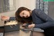 A woman laying on a table with a cell phone in her hand.