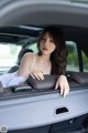 A woman sitting in the back seat of a car.