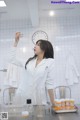 a woman in a lab coat holding a test tube