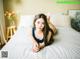 A woman laying on top of a bed in a bedroom.